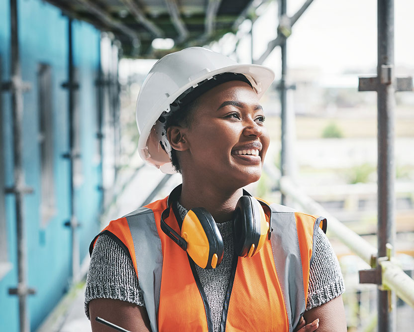 Site supervisor in a high-visibility vest checking a schedule